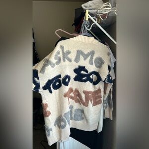 Womens cardigan with lettering and patterns.